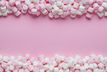 Delicious marshmallows on pink background, flat lay. Space for text