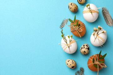 Festively decorated eggs on light blue background, flat lay and space for text. Happy Easter