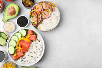 Poke bowls and ingredients on white table, flat lay. Space for text