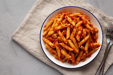Homemade Penne With Tomato Sauce on a Plate, top view. From above, overhead, flat lay. Copy space.