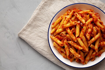 Homemade Penne With Tomato Sauce on a Plate, top view. From above, overhead, flat lay. Copy space.