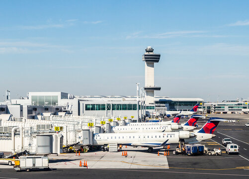 Air Traffic Control Tower and Terminal 4 with Air planes at the gates in JFK Airport