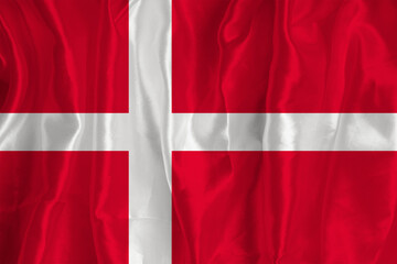 The Danmark flag on a silk background is a great national symbol. Fabric texture The official state symbol of the country..