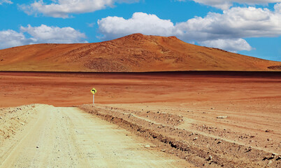Adventure travel in life hostile arid dry barren landscape: Empty sandy dirt track, red desert...
