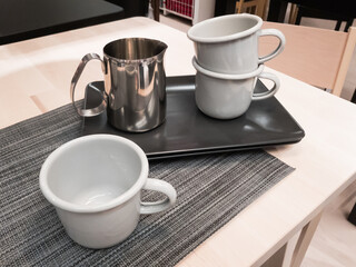 Metallic empty coffee cups and ceramic saucers, still life concept