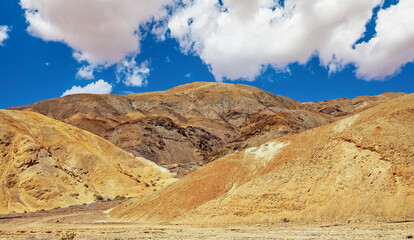 Bare lonely yellowish brown mountain landscape in hot desert without plants - Chile, Atacama region, Pan de Azucar NP