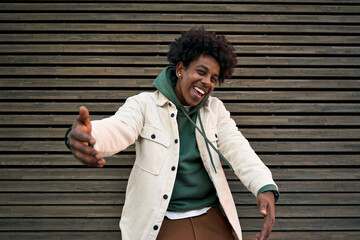 Happy funky funny generation z hipster rapper African American guy dancing, singing, having fun...