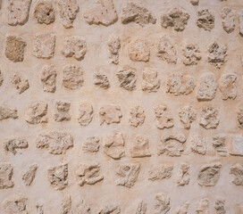 Traditional stone, coral and adobe wall in Sharjah emirate in the United Arab Emirates. Such hand plastered walls were made for centuries in the Arabian Gulf with materials from the desert and sea.