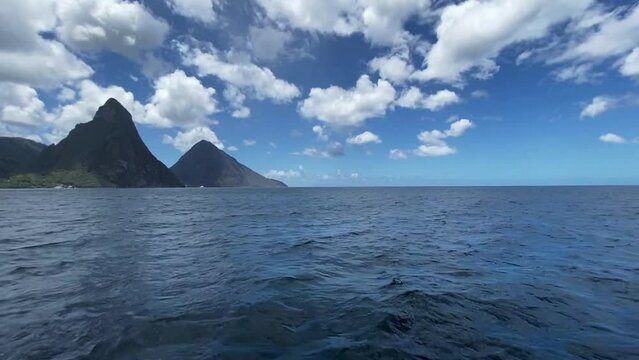 Saint Lucia pitons as seen from the water.  The Pitons are two mountainous volcanic plugs, volcanic spires, located in Saint Lucia. 