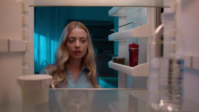 Point of view POV inside refrigerator Caucasian girl hungry woman open fridge at home kitchen look at empty shelves order food products delivery with mobile phone app online service web store shopping