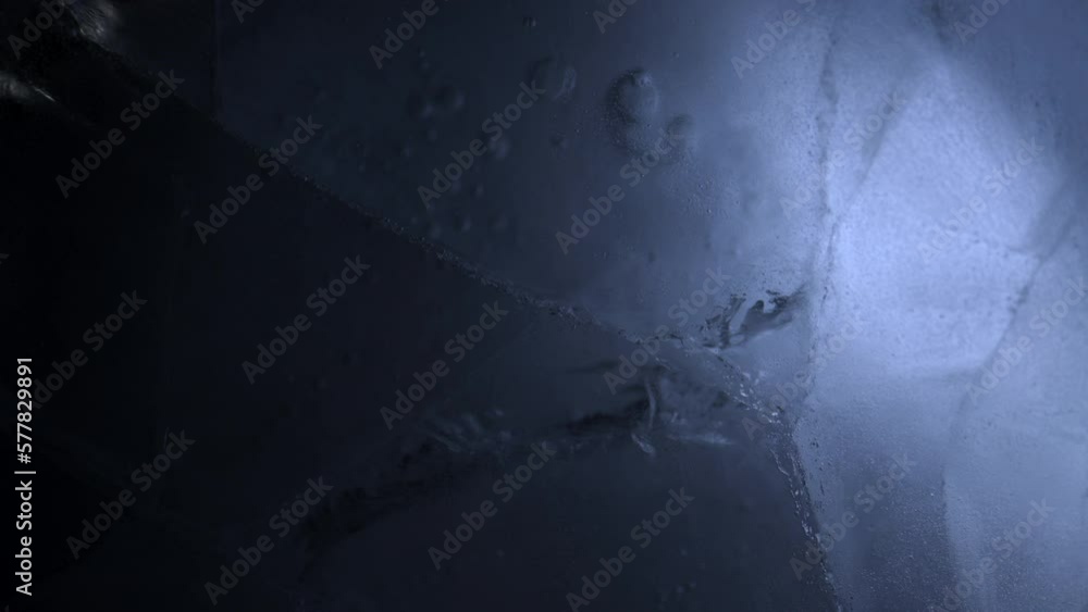 Wall mural Abstract ice background. Blue background with cracks on the ice surface.