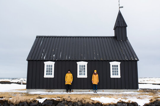 bright couple on the background of a black church