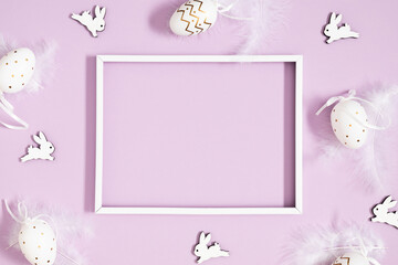 Easter holiday composition. Blank photo frame, decorations beautiful, easter eggs, feathers, bunny...