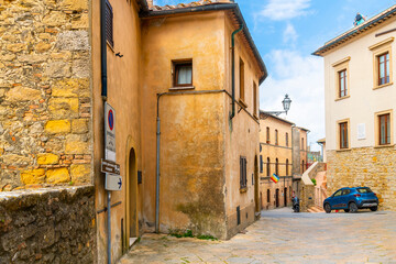 Fototapeta na wymiar Medieval homes and apartments on one of the historic streets of the hill town of Volterra, Italy, in the Tuscany region. 