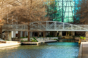 Metal bridge over canal or lake in urban or commercial district in mall or outdoor shopping center in san antonio texas