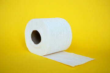  Roll of toilet paper on the yellow background. Tissue for use in the toilet room, used for cleaning the dirt in the bathroom. People are stocking up toilet paper for home.