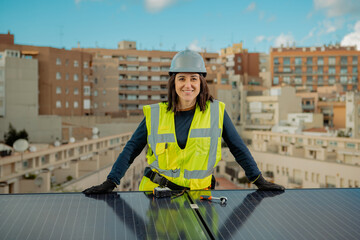 Female electrician engineer portrait by urban Solar Panels in city roof