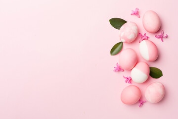 Fototapeta na wymiar Pink Easter eggs on color background, top view