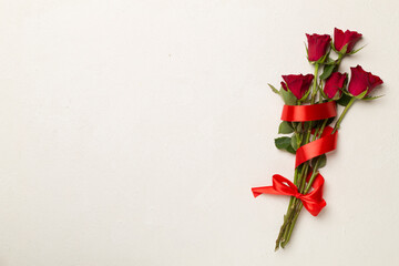 Red roses on concrete background, top view