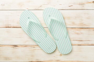 Striped flip flops on wooden background, top view