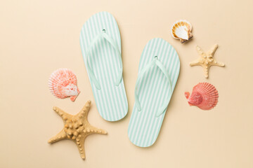 Striped flip flops on color background, top view