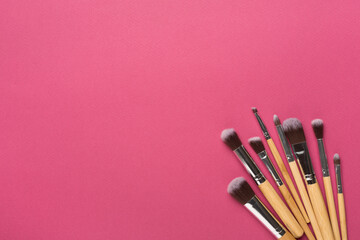 Make up brushes on color background, top view