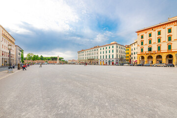 Fototapeta na wymiar The spacious Piazza della Repubblica town square in the Tuscan coastal port town of Livorno, Italy, with the monument statue of Leopoldo II in view in the distance.