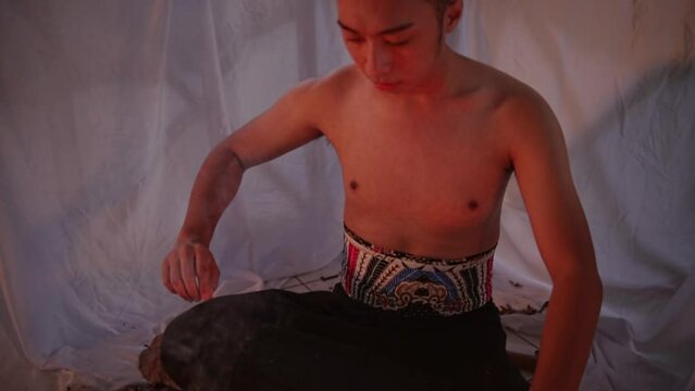 an Asian man asked a shaman to perform a devil ritual using a flute