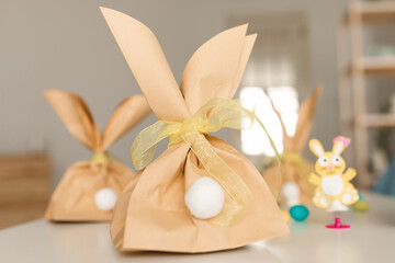 Fototapeta na wymiar Handmade Easter Gift Bags Standing On Table At Home
