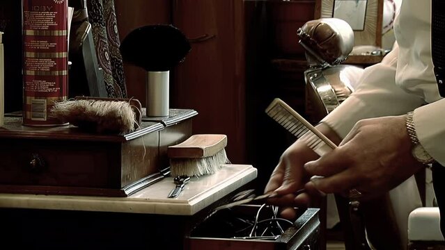 A Hairdresser Cleaning a Comb with Brush and Picking Up Scissors at Barbershop. Close Up. 4K Resolution.