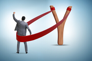 Businessman being launched from slingshot in career concept