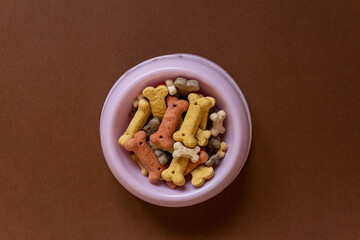 Close up of a Dog bowl on brown background. Dog accessories. Minimalistic background.	