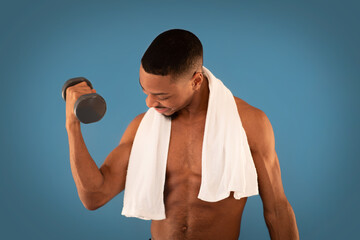 Muscular african american man exercising with barbell on blue