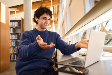 Smiling Hispanic student having online conference participant speaking and listening in virtual chat