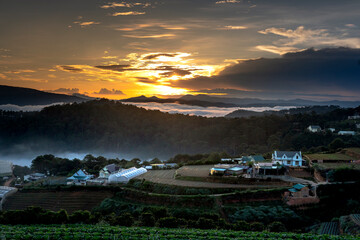 Beautiful images of the radiant dawn with reflecting rays in the hills and mountains in the fanciful clouds in the area near Da Lat town