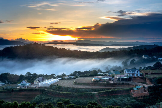 Beautiful images of the radiant dawn with reflecting rays in the hills and mountains in the fanciful clouds in the area near Da Lat town