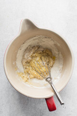 Vanilla cake batter in a mixing bowl, process of making cupcakes