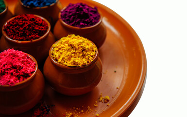 Various Holi paints in pots on a tray. Colorful background for the national Indian holiday Happy Holi