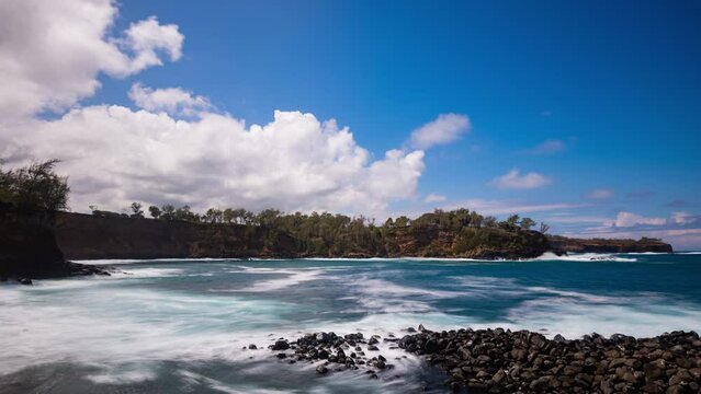 Timelapse - Ocean waves splashing the rocks with beautiful cloudscape above at North Point in Big Island, Hawaii
