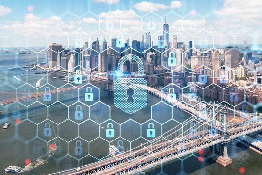 Aerial panoramic city view of Lower Manhattan. Brooklyn and Manhattan bridges over East River, New York, USA. The concept of cyber security to protect confidential information, padlock hologram