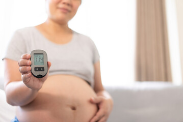 Pregnant woman using insulin test on pregnancy time