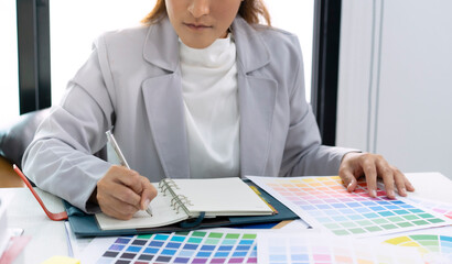 Businesswoman working and analyzing about color with color bar