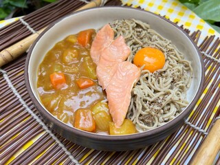 Salmon spinach nooddle with curry sauce and yolk on top