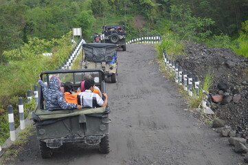Yogyakarta, Indonesia - 12 Decembre 2021 : Offroad car rides, jeep cars, Merapi Yogjakarta Indonesia lava tour, one of the famous rides in Indonesia © ipung