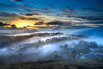 Fototapeta na wymiar Beautiful images of the radiant dawn with reflecting rays through the fanciful clouds on over the pine forests, which created an impressive breathtaking scene of highlands in the morning in Dalat, VN