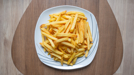 French fries on a wooden background