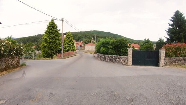 Camino de Invierno - a paved road passing through  Penasillas village - Chantada, province of Lugo, Galicia, Spain - June 2022