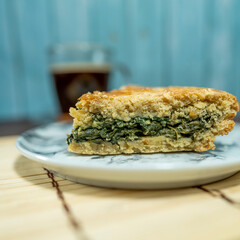 slice of chard tart served with coffee