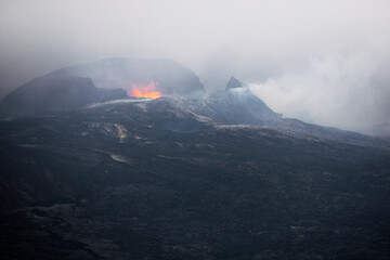 Smoky volcano with bubbling lava