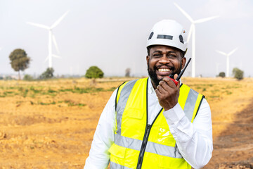 Front view of happy african american man engineer wearing safety helmet and reflective vest...
